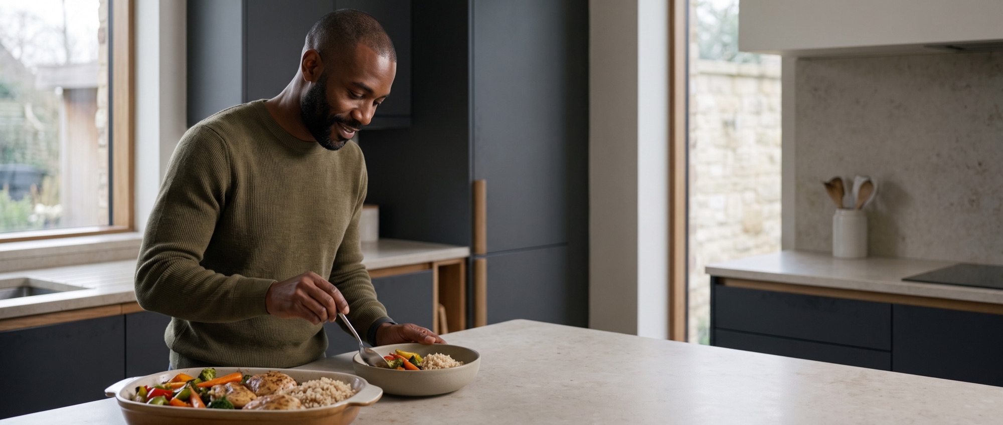 Man serving a meal in his kitchen