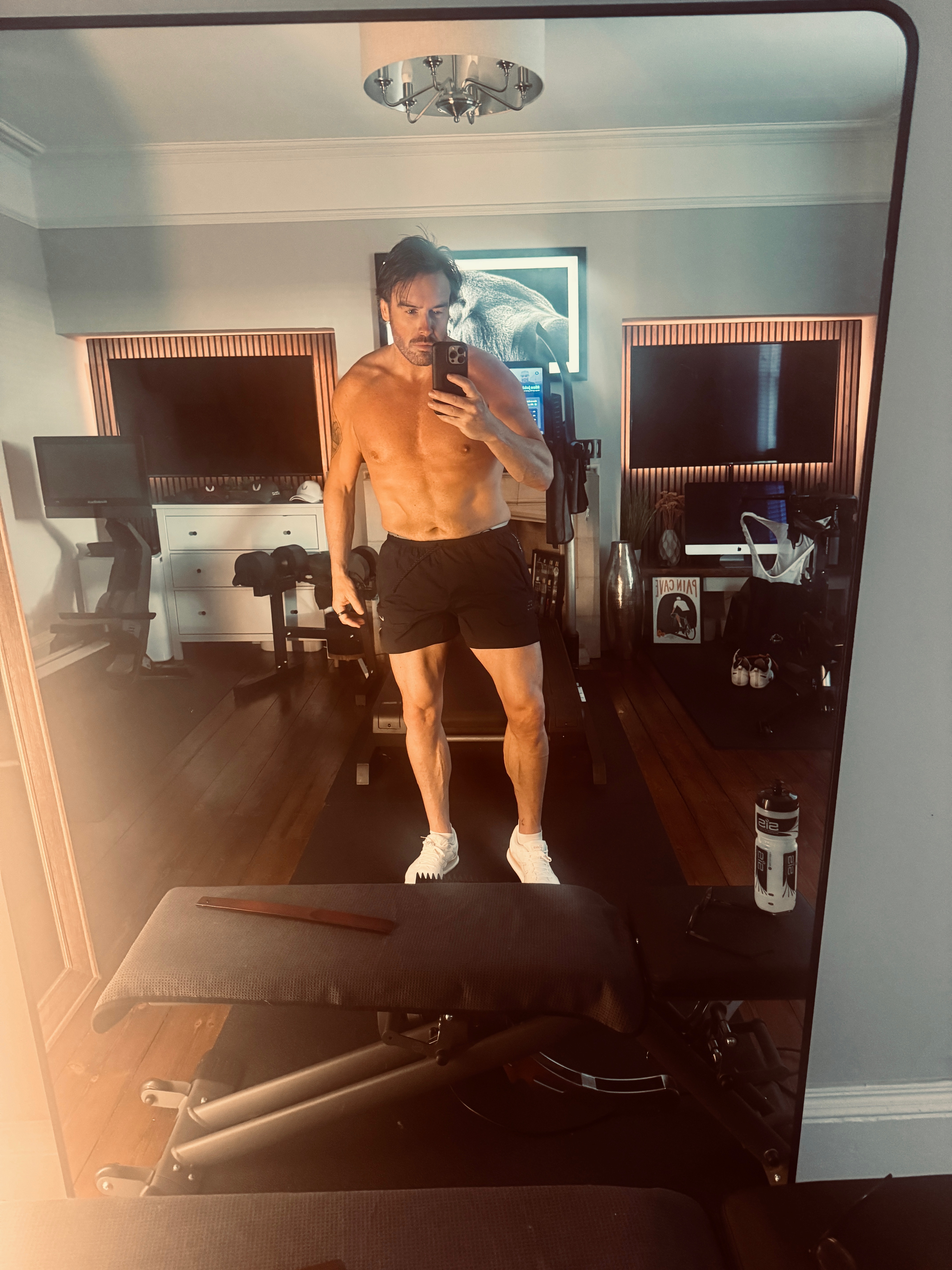 Ben taking a mirror photograph in his home gym