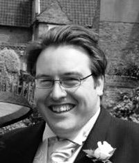 Ben smiling in a suit before he started running