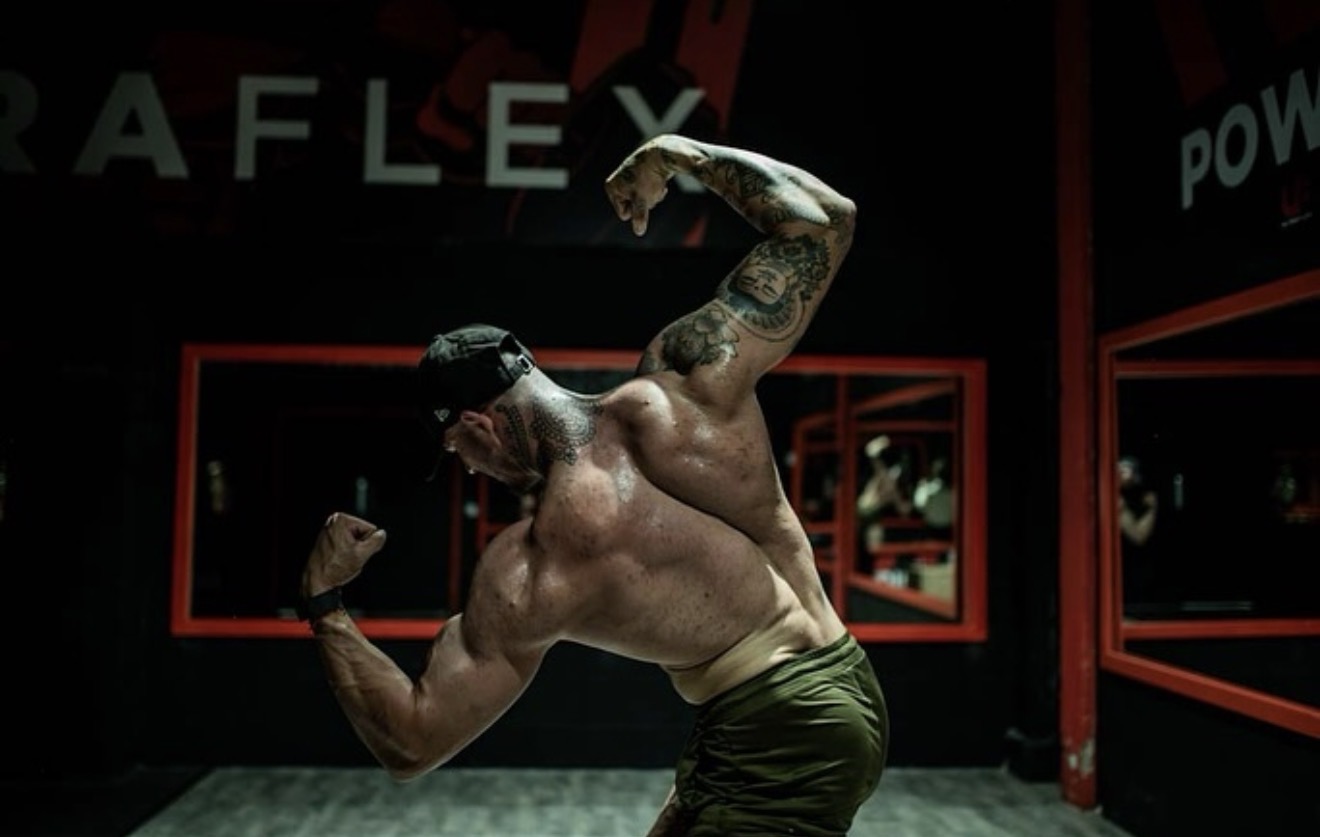 Luke Masters posing in the gym